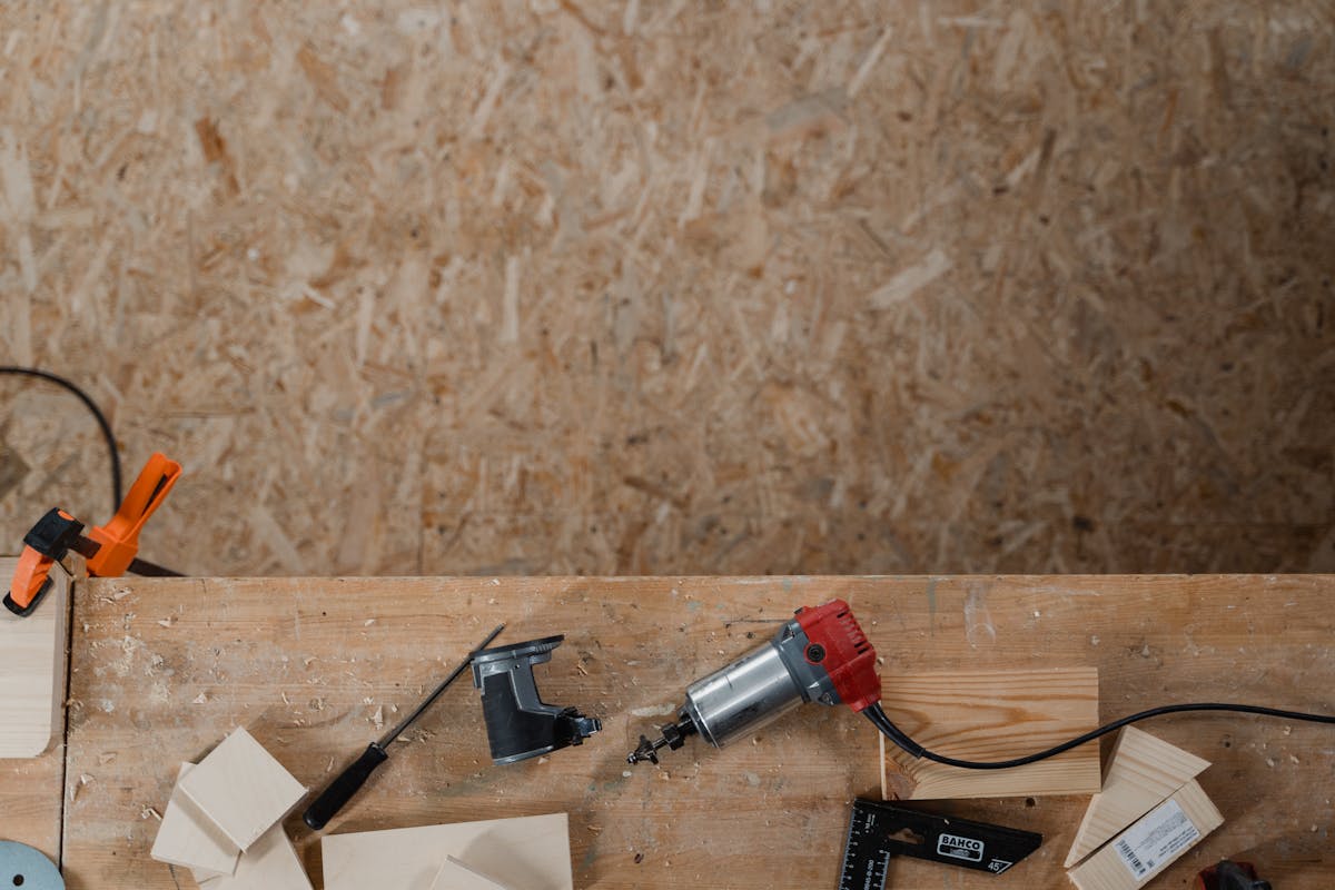 Carpentry tools laid out on a wooden workbench ready for a DIY fence weekend build