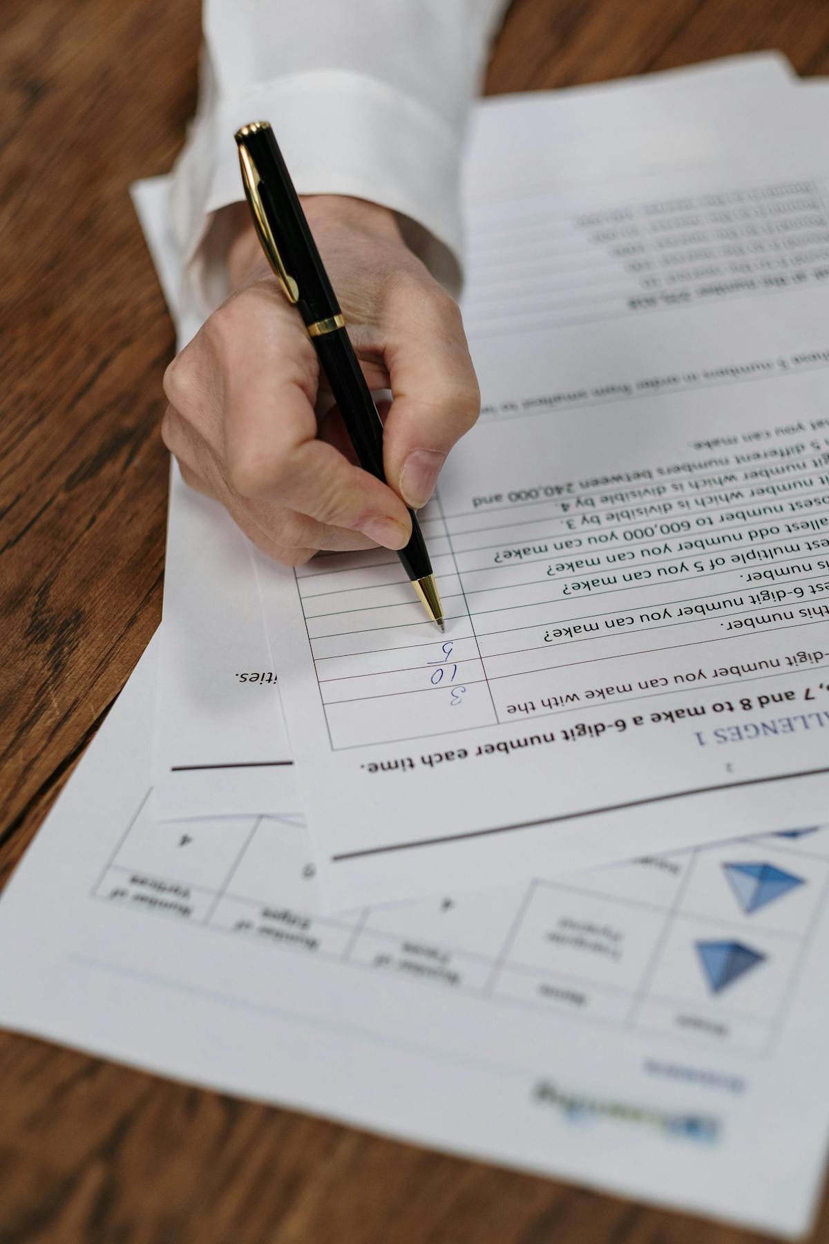 Hand reviewing permit paperwork at a desk before starting a residential fence project