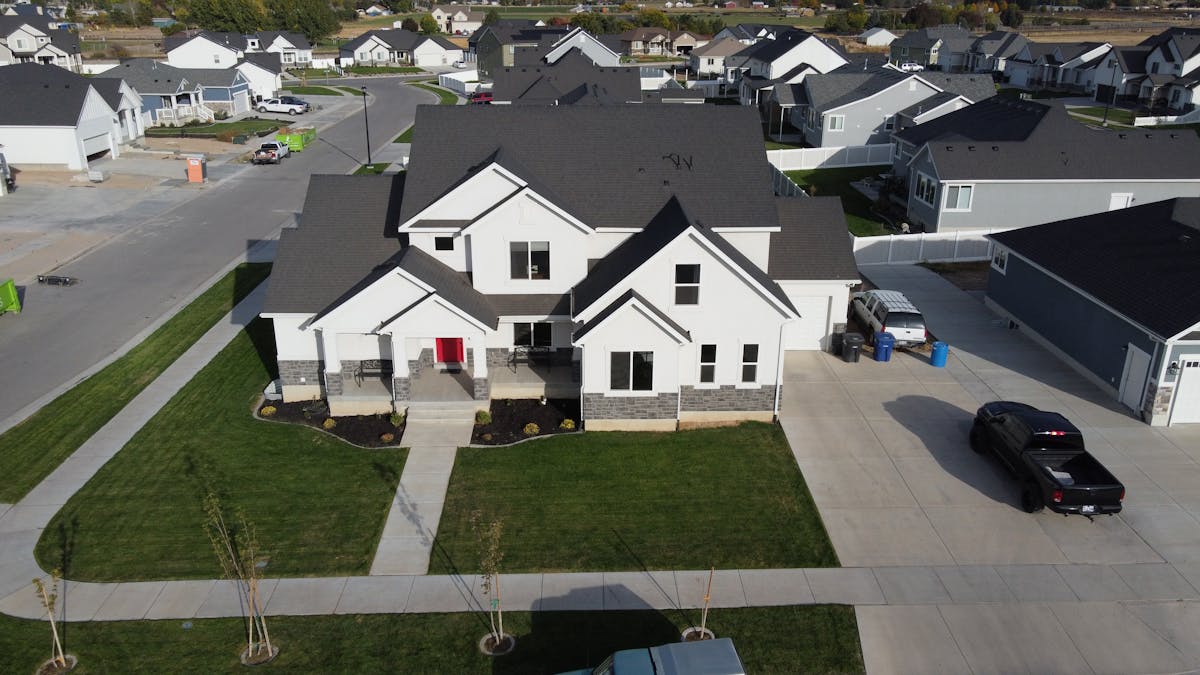 Aerial view of a suburban HOA neighborhood showing uniform lot lines and consistent fencing